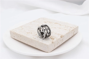 Macro detail of vintage hollow crown ring with cross emblem on stone pedestal