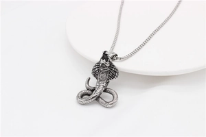 Macro shot of a retro cobra snake pendant with detailed scales and vintage finish