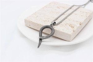 Macro shot of retro steel snake pendant with detailed scales and sturdy box chain