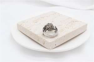 Close-up of vintage silver dragon ring with detailed hollow engraving on stone base