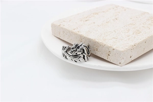 Detailed close-up of a vintage dragon relief carved on a titanium steel ring for men