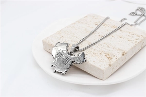 Close-up of China map pendant necklace in titanium steel on natural stone stand
