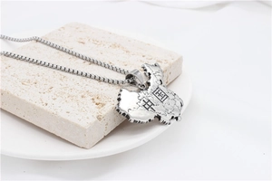 Detailed silver China map pendant with engraved provinces on minimalist stone background