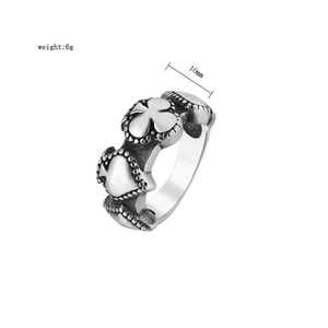 Macro view of vintage spade ring showing 10mm width and embossed clover details