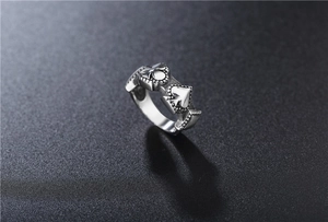 Macro shot of vintage spade poker patterns on antique silver stainless steel ring