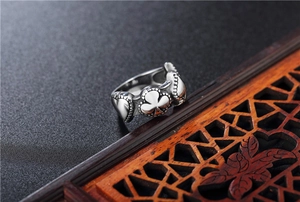 Close-up of vintage spade and heart relief patterns on a stainless steel poker ring