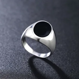 Minimalist silver-polished signet ring for men featuring a sleek black enamel round inlay