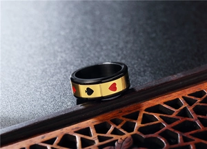 Macro shot of rotatable black and gold poker card spinner ring made of durable titanium steel