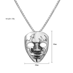 Detailed view of skull mask pendant with totem engraving and square pearl chain