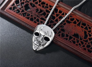 Macro detail of gothic punk bat skull mask pendant in polished silver stainless steel
