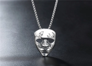Detailed shot of vintage silver bat skull mask pendant with intricate gothic engravings