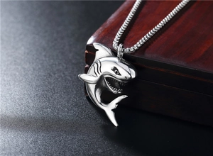 Macro shot of antique silver shark pendant showing detailed shark teeth and gills