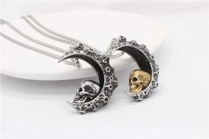 Detail of gothic crescent moon and skull pendant necklace with vintage texture