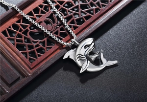 Macro detail of silver shark pendant in titanium steel with intricate gill and fin texture