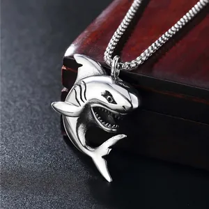 Punk style shark pendant necklace in silver stainless steel on wooden background