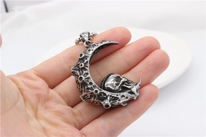 Detailed view of gothic crescent moon skull pendant with oxidized vintage texture