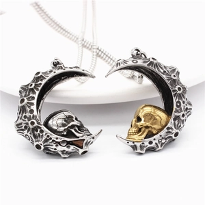 Gothic crescent moon pendant necklace with skull detail and vintage stainless steel finish