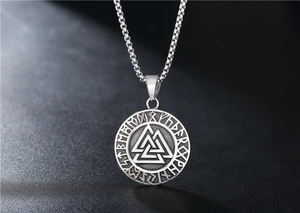 Close-up of Viking Valknut symbol pendant with Runic letters on retro steel necklace