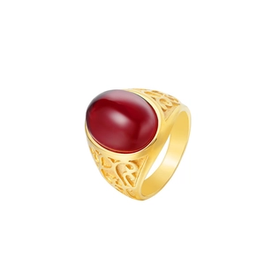 Macro view of vintage golden titanium ring featuring oval red cat eye stone and filigree