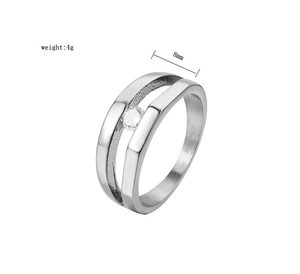 Detail of silver titanium steel ring with hollow design and center cubic zirconia stone