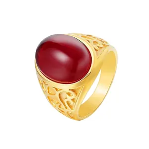 Retro gold titanium ring featuring a polished oval red gemstone and hollow floral patterns