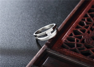 Detail of silver titanium ring featuring a double hollow band with a floating round zircon
