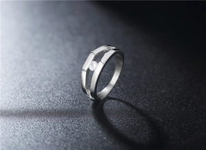 Detailed side view of silver titanium steel ring with double-layer hollow band and zircon