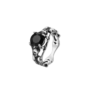 Detailed close-up of retro gothic skull ring featuring a faceted black gemstone inlay