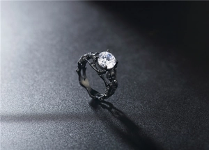 Macro view of gothic skull ring in black plated steel with round cubic zirconia stone