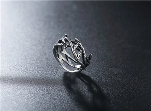 Macro shot of silver crown of thorns ring with vintage oxidized finish and steel texture