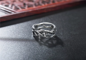 Macro shot of vintage silver thorn crown ring made of titanium steel with detailed shadows