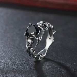 Vintage stainless steel skull ring featuring a large black faceted gemstone in punk gothic style