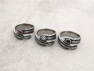 Close-up of retro feather rings with inlaid red, black, and white round gemstones