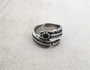 Macro shot of retro feather ring detail with intricate textures and black gemstone
