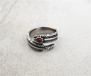 Macro view of retro feather ring in titanium steel with a centered red gemstone detail
