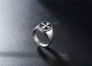 Macro view of vintage silver punk cross ring with gothic engraved disk detail