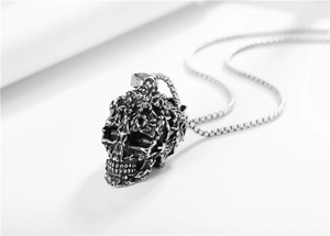 Macro shot of punk style skull pendant with intricate micro-figure texture on box chain
