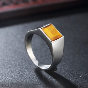 Minimalist stainless steel ring featuring a rectangular tiger eye stone in a macro side view