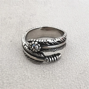 Vintage titanium steel feather ring with center gemstone and intricate carved texture