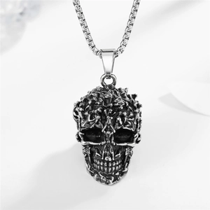 Gothic style stainless steel skull pendant with box chain on a clean white background