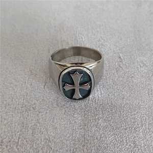 Retro stainless steel ring with oval signet and cross emblem shown from 45-degree angle