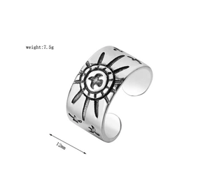 Detail showing retro eagle and sun totems on 12mm wide adjustable stainless steel ring