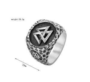 Macro shot of Viking Valknut stainless steel ring with rustic hammered texture and symbols