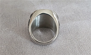Macro shot of polished silver titanium steel ring showing thick inner band texture