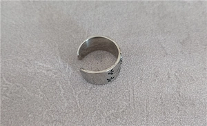 Detail of vintage eagle ring with adjustable open band and star pattern engraving