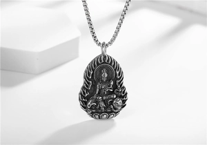 Macro detail of Buddhist Guanyin pendant on stainless steel box chain necklace