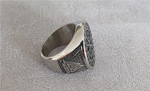 Macro detail of Viking compass and Valknut symbols on engraved titanium steel ring