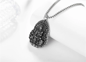 Macro view of vintage stainless steel Guanyin pendant with detailed flame engraving