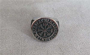 Macro detail of Nordic Viking compass Vegvisir symbol engraved on stainless steel ring