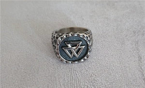 Detail of Viking Valknut ring with hammered texture and stainless steel relief patterns